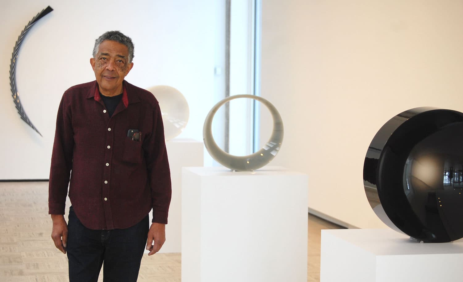 Fred Eversely at his exhibit &quot;Black, White, Gray&quot; at Brandeis University’s Rose Art Museum. (Greg Cook/WBUR)