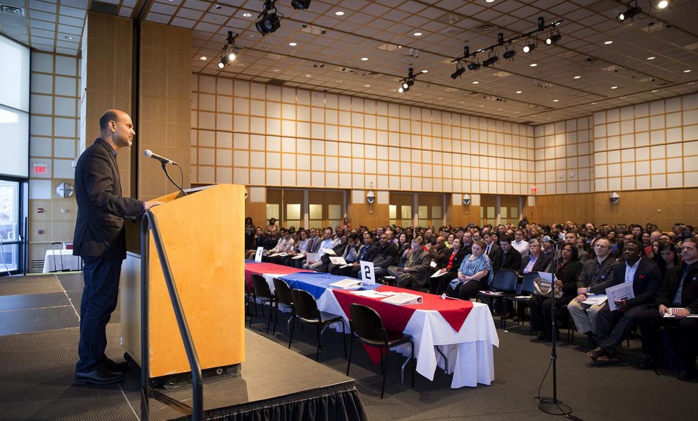 Mohamad Ali, the CEO of Carbonite, shared his own immigrant story during a naturalization ceremony at JFK Library on Wednesday. (Robin Lubbock/WBUR)