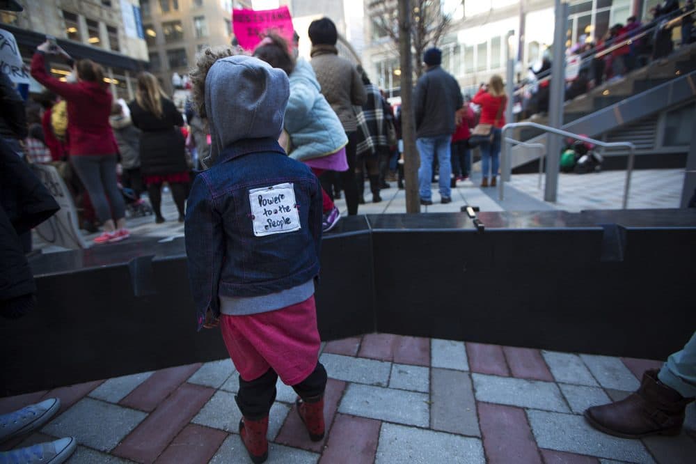 3-year-old Ella Berg Power of Worcester wears a &quot;power To The People&quot; patch on her back. (Jesse Costa/WBUR)