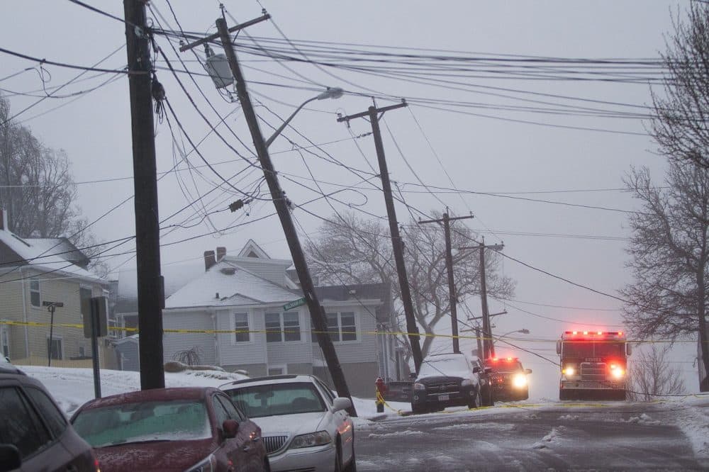 High winds took down a a light pole and power lines on Leverett Avenue in Revere. (Jesse Costa/WBUR)