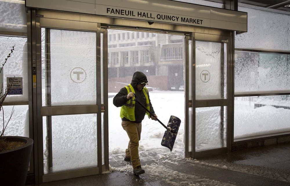 Staff keep the entrances clear of snow at the MBTA's Government Center Station. (Robin Lubbock/WBUR)