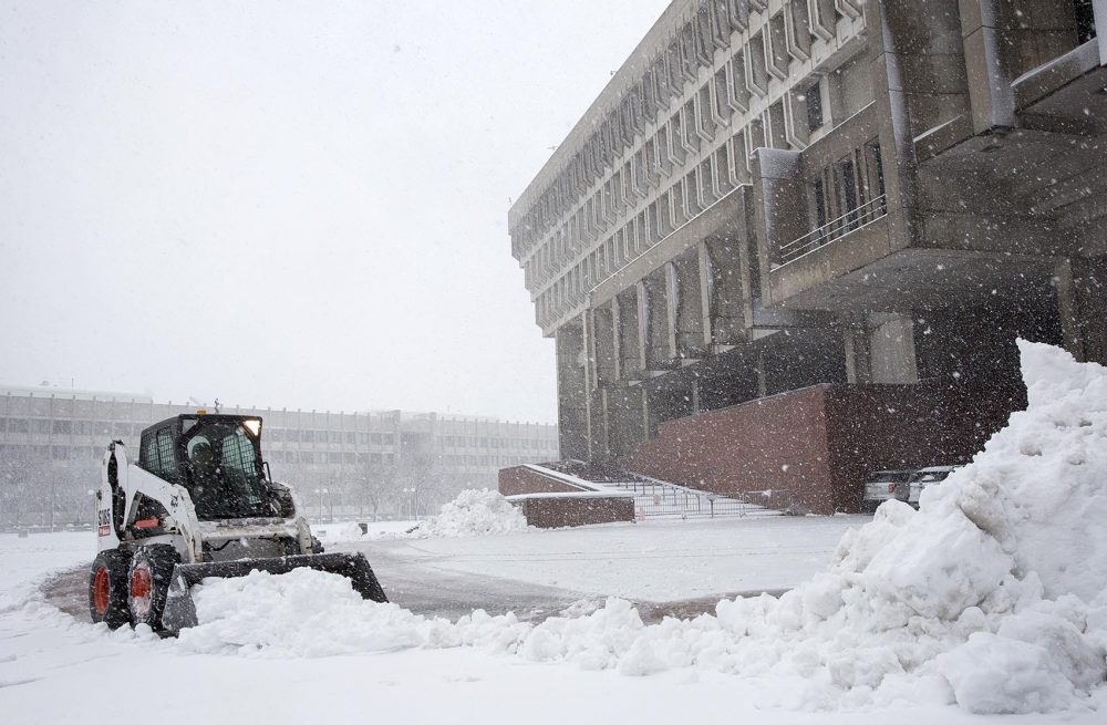 A Bobcat cleared snow away from the entrance to Boston City Hall. (Robin Lubbock/WBUR)