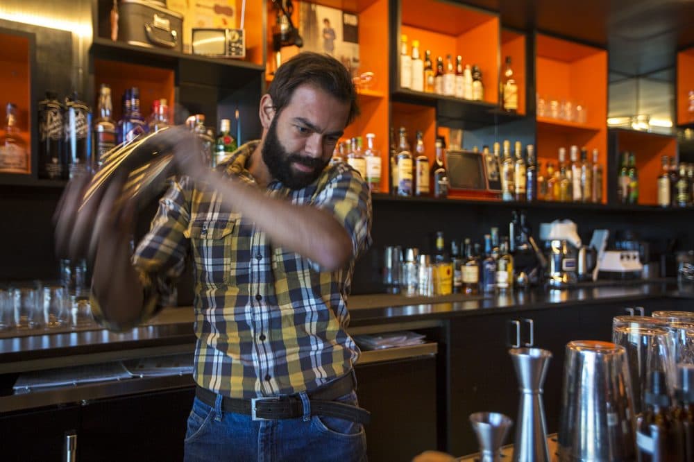 Augusto Lino, a tip-earning bartender at Area Four Boston, has told people, &quot;You never talk about your money in front of the kitchen, because these guys are working harder and making the same amount of money.&quot; (Jesse Costa/WBUR)