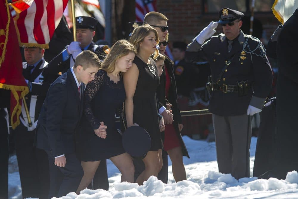 The children of firefighter Joseph Toscano follow behind his casket on their way into St. Patrick's Church. (Jesse Costa/WBUR)