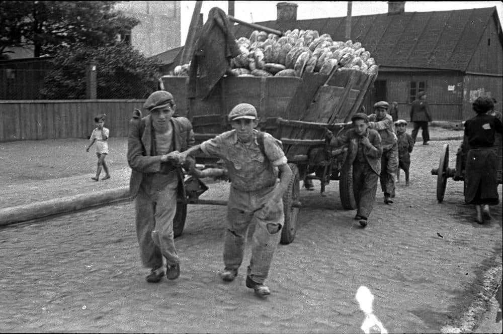Henryk Ross photo of Lodz Ghetto men hauling a cart for bread distribution, 1942. (Courtesy, Museum of Fine Arts, Boston)