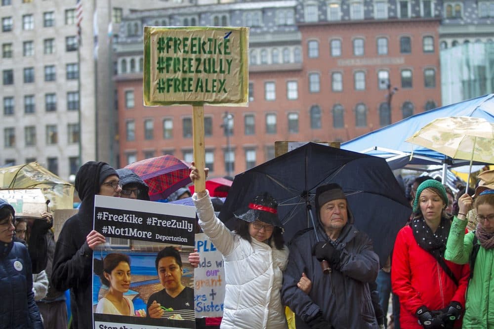 Protesters outside the JFK Federal Building in Boston call for the release of three Vermont immigration rights activists who were arrested by ICE agents earlier this month. (Jesse Costa/WBUR)