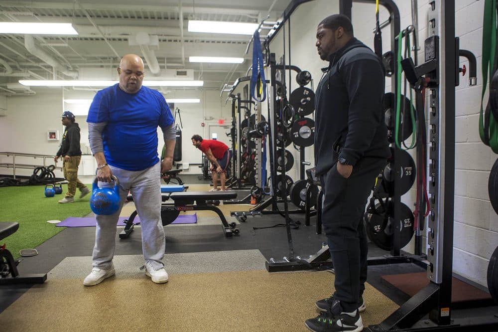 After a couple of stints behind bars, Angel LaCourt, right, is now a trainer at ICW. (Jesse Costa/WBUR)