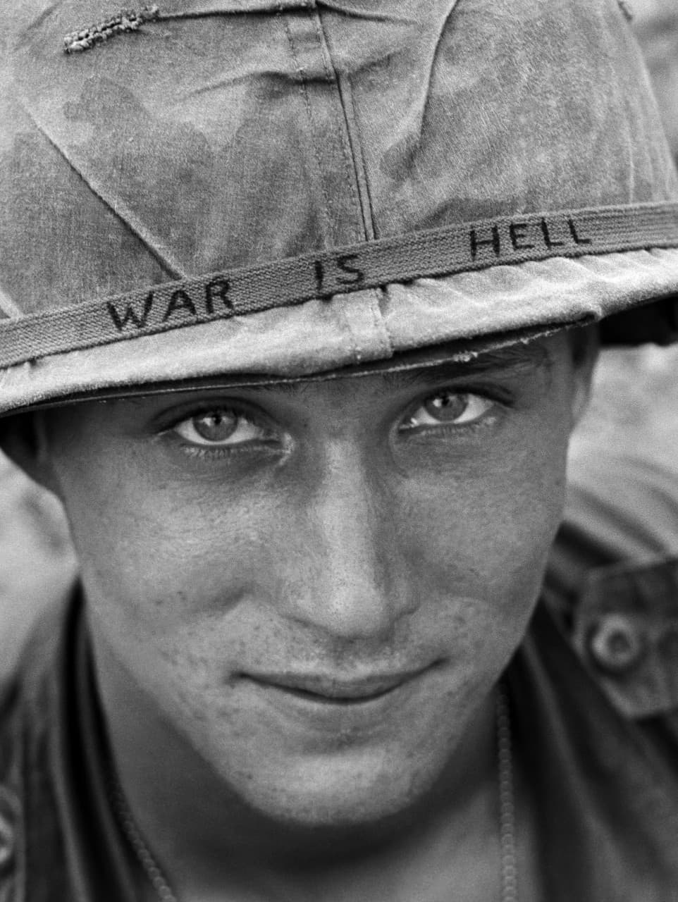 An unidentified American soldier wears a hand-lettered slogan on his helmet, June 1965. The soldier was serving with the 173rd Airborne Brigade on defense duty at the Phuoc Vinh airfield. (Horst Faas/AP)
