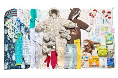 Pictured: The 2016 Finnish baby box included many outfits, a book, a toy, a toothbrush, a thermometer. Not shown: the cardboard bed. (Photo courtesy Annika Söderblom, ©Kela)