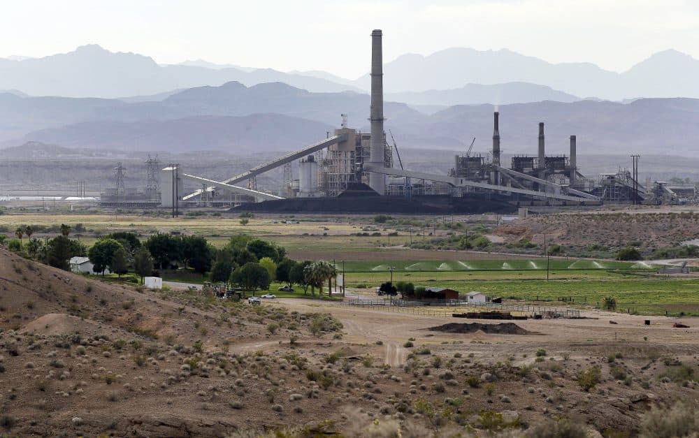 Pictured: This May 14, 2012 file photo shows the Reid-Gardner power generating station near a farm on the Moapa Indian Reservation in Moapa, Nev. NV Energy wants to shut down the coal-fired power plant in southern Nevada 10 months earlier than planned, and is requesting to build a new 100-megawatt solar farm in Boulder City, Nev. NV Energy has faced pressure to shift toward renewable energy by rooftop solar proponents and large casino companies that are leaving the monopoly to pursue cleaner options. (Julie Jacobson/AP)