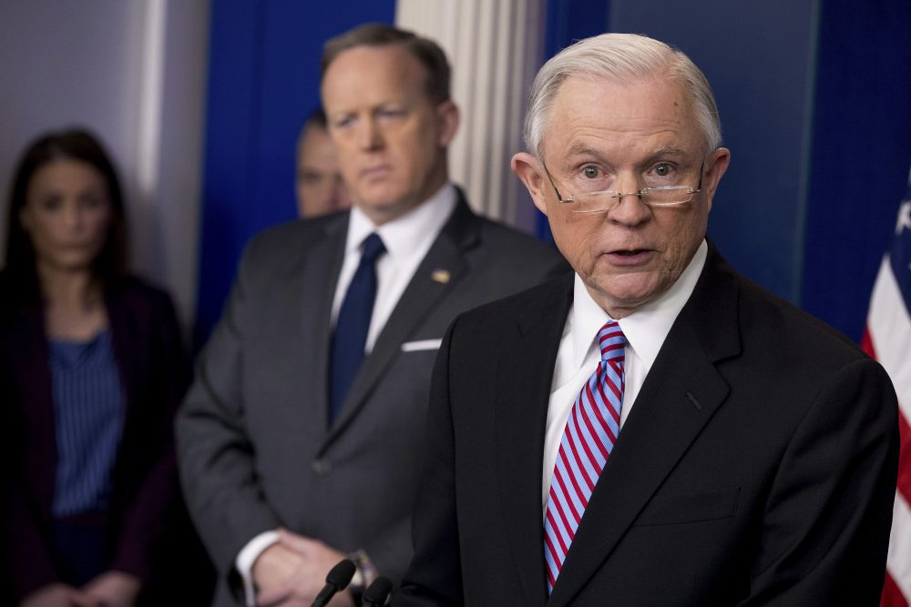 Attorney General Jeff Sessions, right, accompanied by White House press secretary Sean Spicer, talks to the media Monday. (Andrew Harnik/AP)