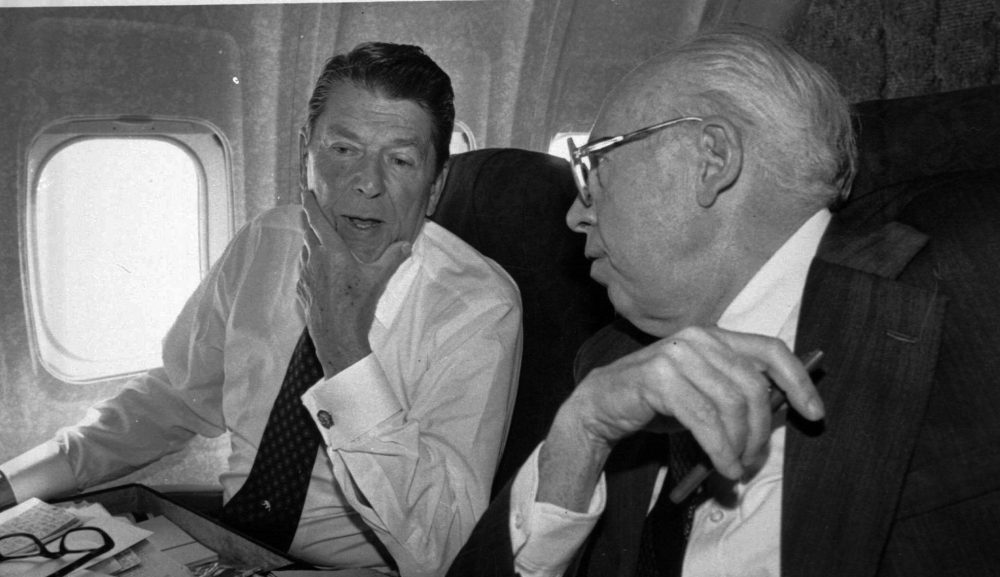 Ronald Reagan huddles with his campaign chairman William Casey, aboard the plane on their way from Los Angeles to San Francisco June 6, 1980. (AP)