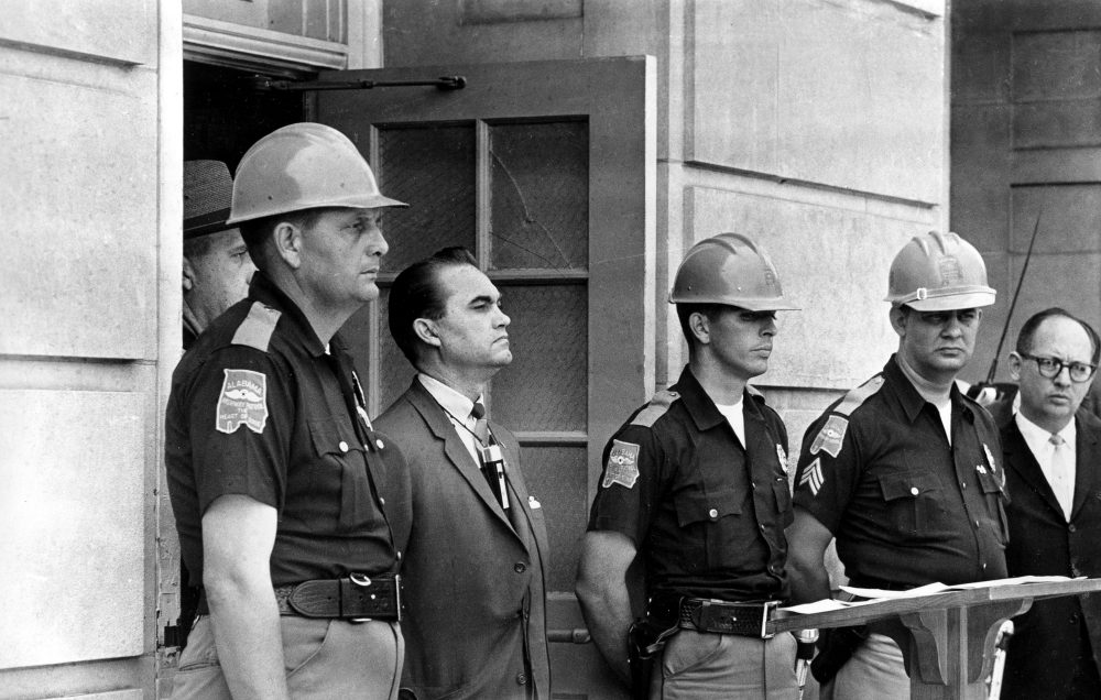 Gov. George Wallace blocks the entrance to the University of Alabama as he turned back a federal officer attempting to enroll two black students at the university campus in Tuscaloosa, Ala., June 11, 1963. (AP Photo/File)
