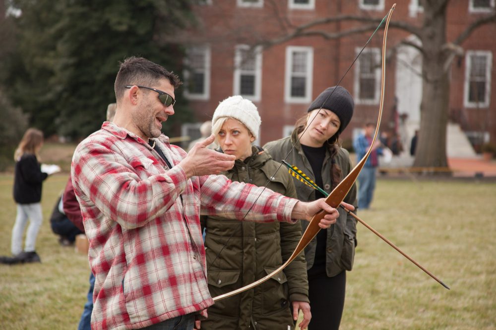 Bill Schindler often takes students out on the campus green to teach them how to use bow and arrow, as well as more primitive weapons like the atlatl. (Courtesy Washington College)