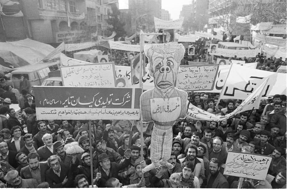 An effigy of President Carter is held aloft during a mass demonstration as thousands of factory workers show their support for the students holding hostages inside the U.S. Embassy in Tehran, Dec. 23, 1979. (Jacques Langevin/AP)