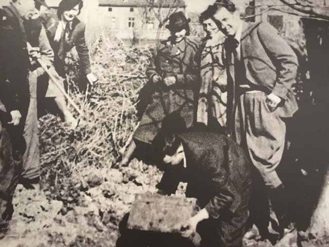 Henryk Ross digs up his hidden box of photos and negatives in 1945. (Courtesy MFA Boston)