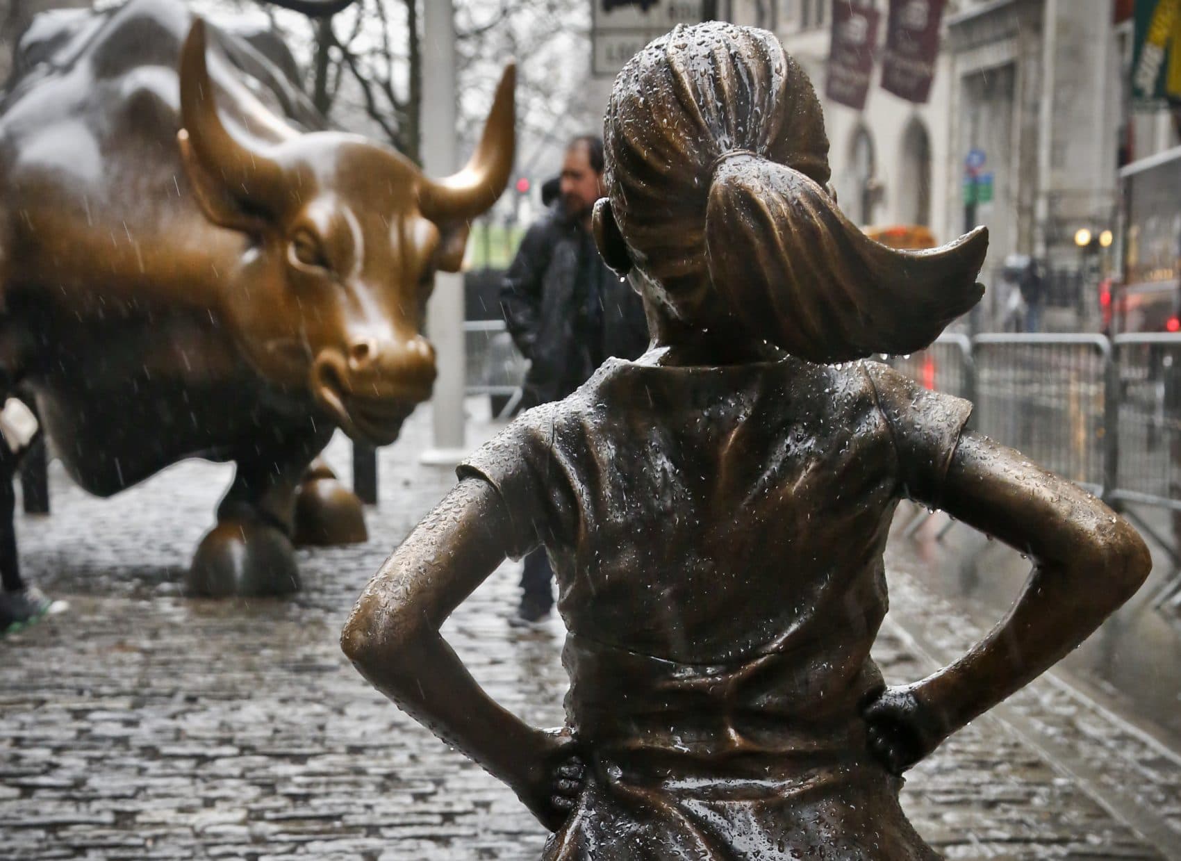 The "Fearless Girl" statue opposite the "Charging Bull" statue in New York is part of an effort to the need for more women on corporate boards. Funded by Boston-based State Street Global Advisors, an inscription at the base reads, "Know the power of women in leadership. She makes a difference." (Bebeto Matthews/AP)