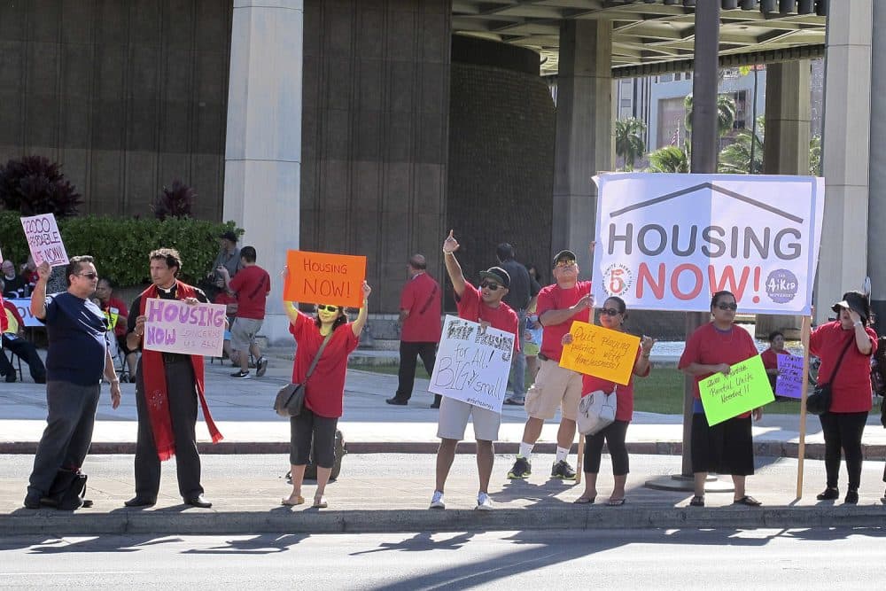 In this April 21, 2016 photo, affordable housing and homeless advocates rally outside the state capitol in Honolulu. Hawaii. (Cathy Bussewitz/AP)
