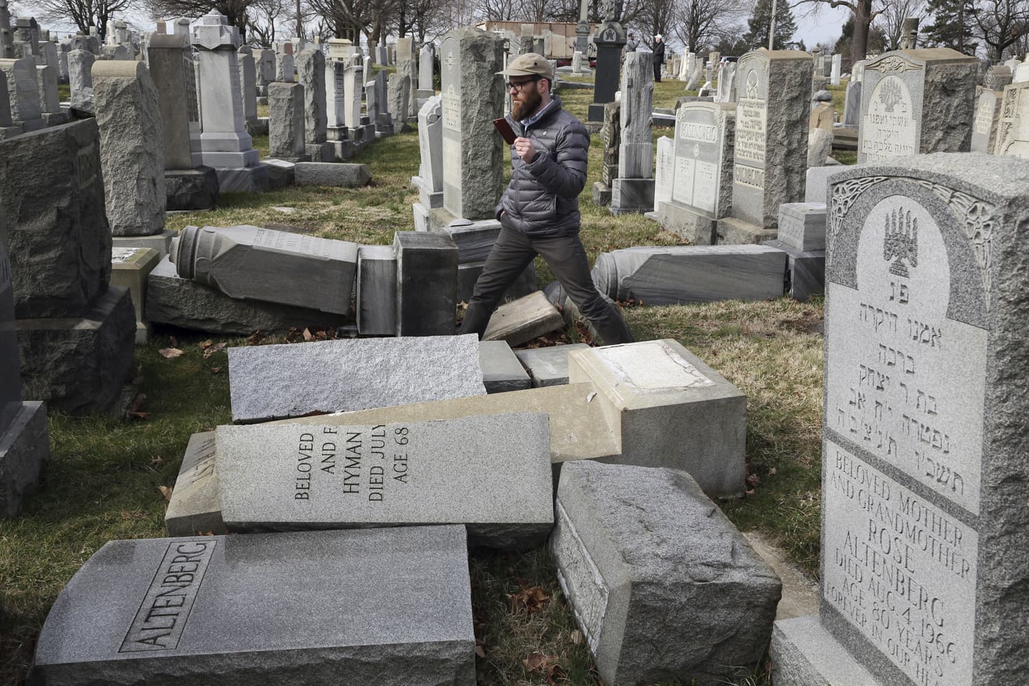 Rabbi Joshua Bolton of the University of Pennsylvania's Hillel center surveys damaged headstones at Mount Carmel Cemetery in Philadelphia. (Jacqueline Larma/AP)