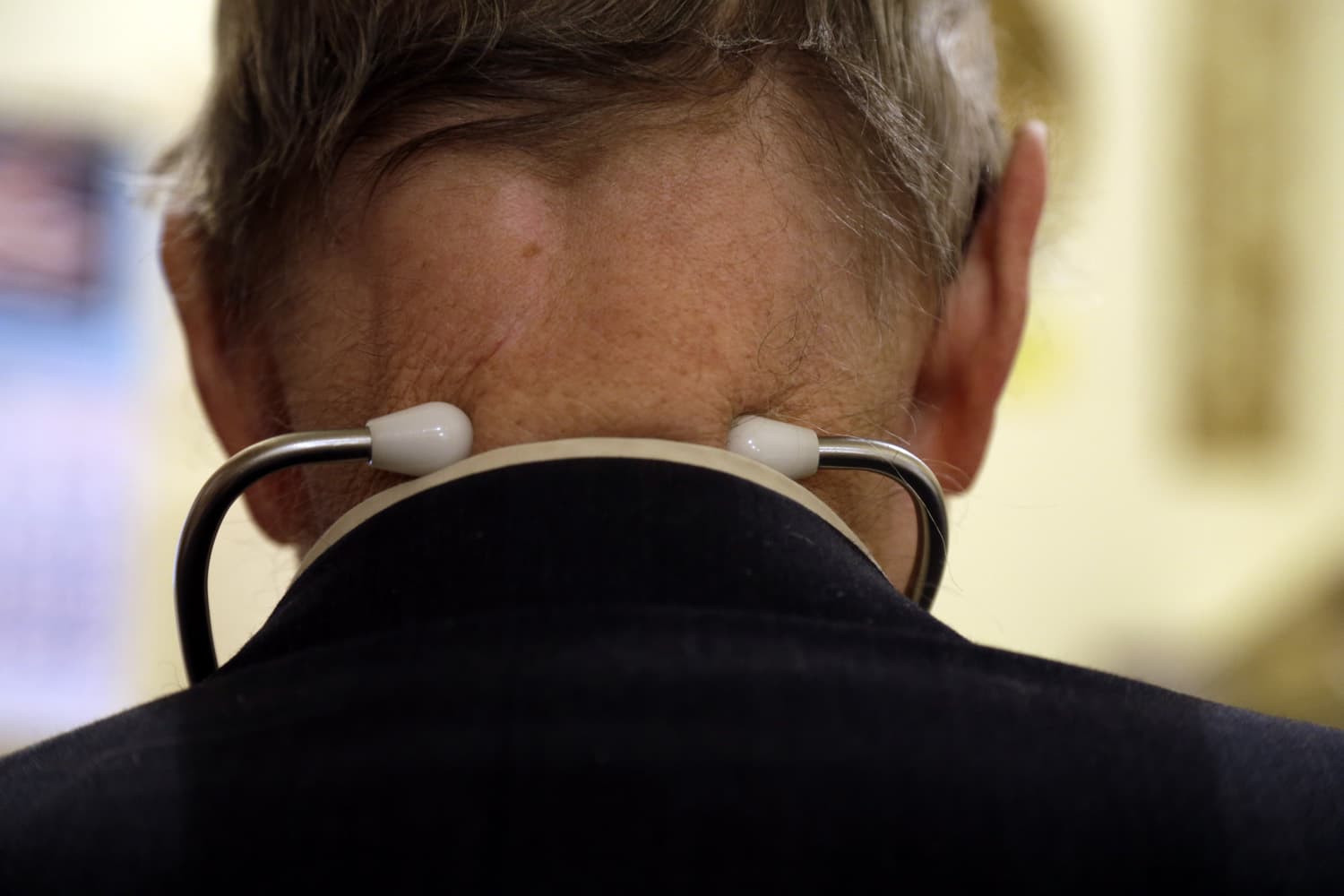 In this Tuesday, Oct. 30, 2012 photo, Dr. Russell Dohner wears a stethoscope around his neck as he tends to patients in his office in Rushville, Ill. (Jeff Roberson/AP)