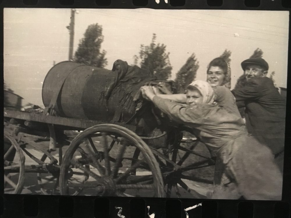 Sanitation workers, or “fecal workers,” in Lodz push a septic tank. (Courtesy Henryk Ross/MFA Boston)