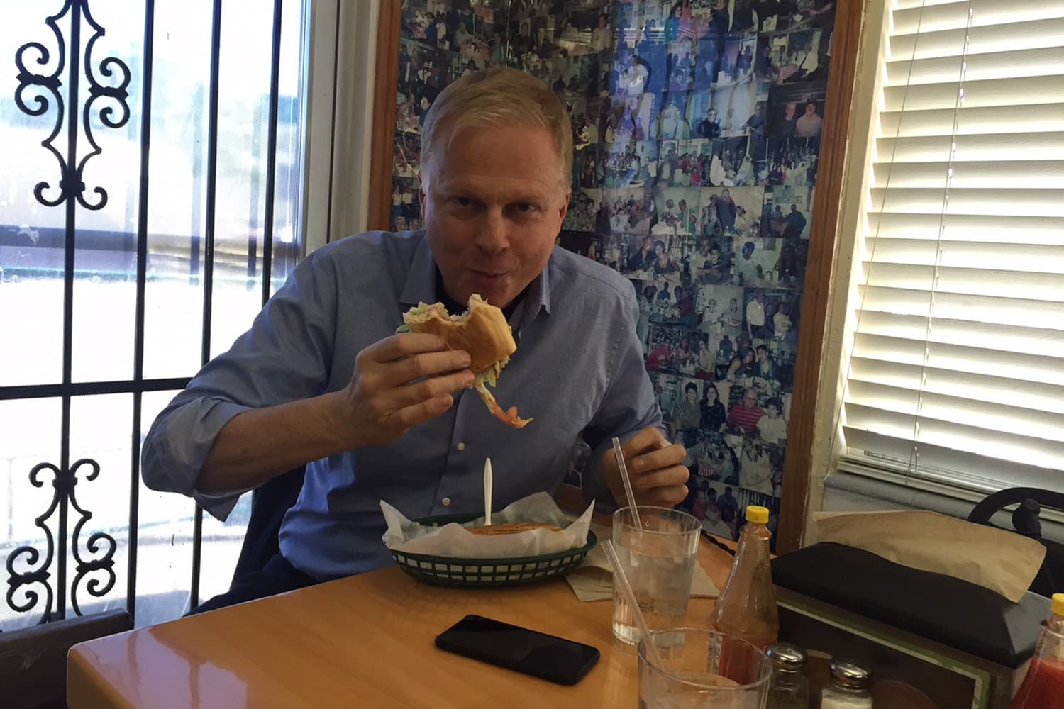 On Point host Tom Ashbrook enjoys a Cubano sandwich at the West Tampa Sandwich Shop during the On Point visit to Tampa, FL. (Eileen Imada/WBUR)