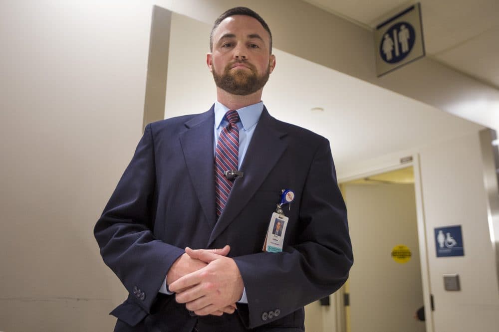 Ryan Curran, police and security operations manager at Massachusetts General Hospital, stands in front of the bathrooms in the main lobby of the hospital's lobby. (Jesse Costa/WBUR)
