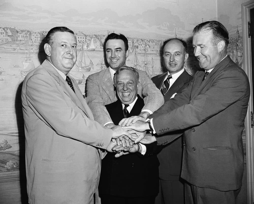 Leo Ferris (second from left) and representatives of the NBL and BAA shake hands after agreeing to a merger in 1949. (John Lent/AP)