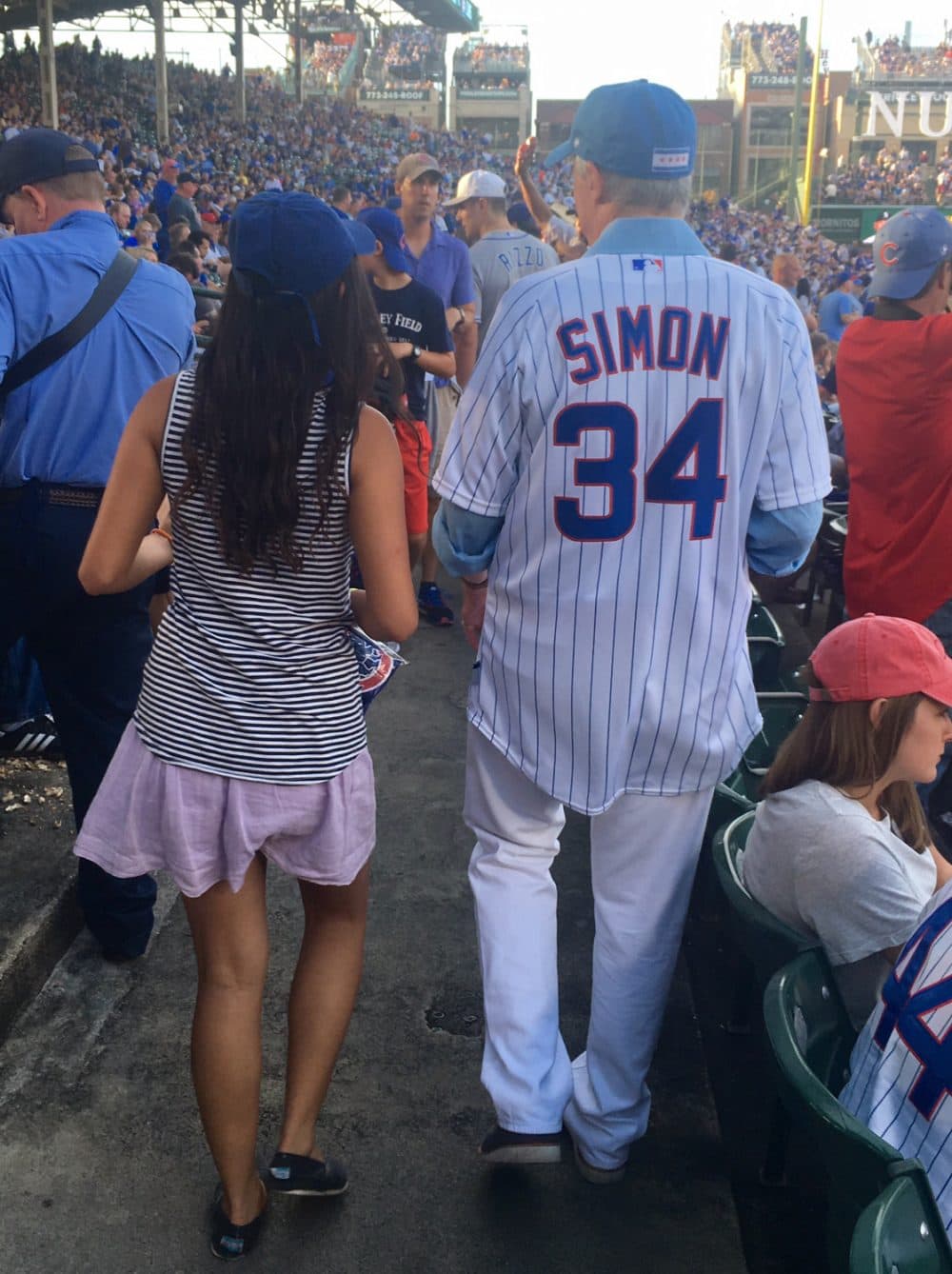 Simon with his daughter after throwing out the first pitch at Wrigley Field before a game in 2016. (Courtesy Scott Simon)