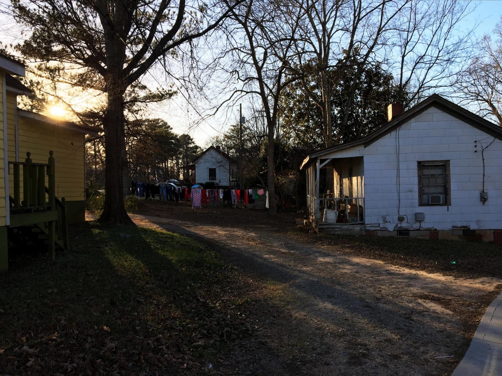 The sun sets on the Rose Hill neighborhood of Porterdale, Georgia. These homes were built in the early 20th century for African-American workers at the nearby cotton mill. (Sam Whitehead/GPB)