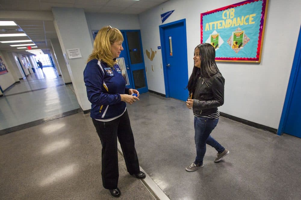 Headmaster Ligia Noriega-Murphy speaks with a student in the hallway in between classes. (Jesse Costa/WBUR)