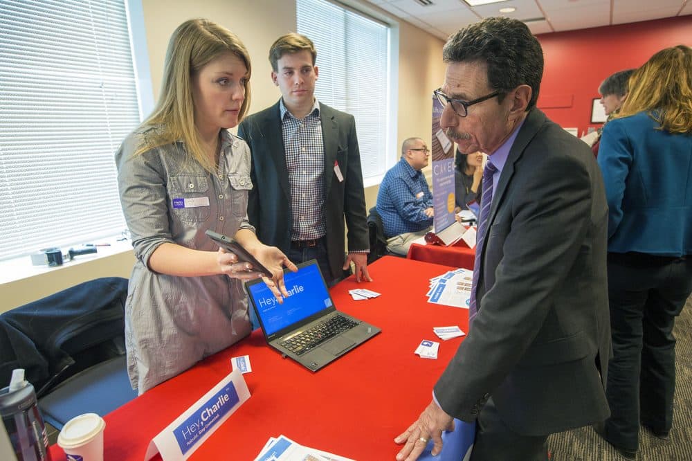 Hey, Charlie co-founders Emily Lindemer and Vincent Valant explain some of the features of their app at the Digital Health Innovation Showcase. (Jesse Costa/WBUR)