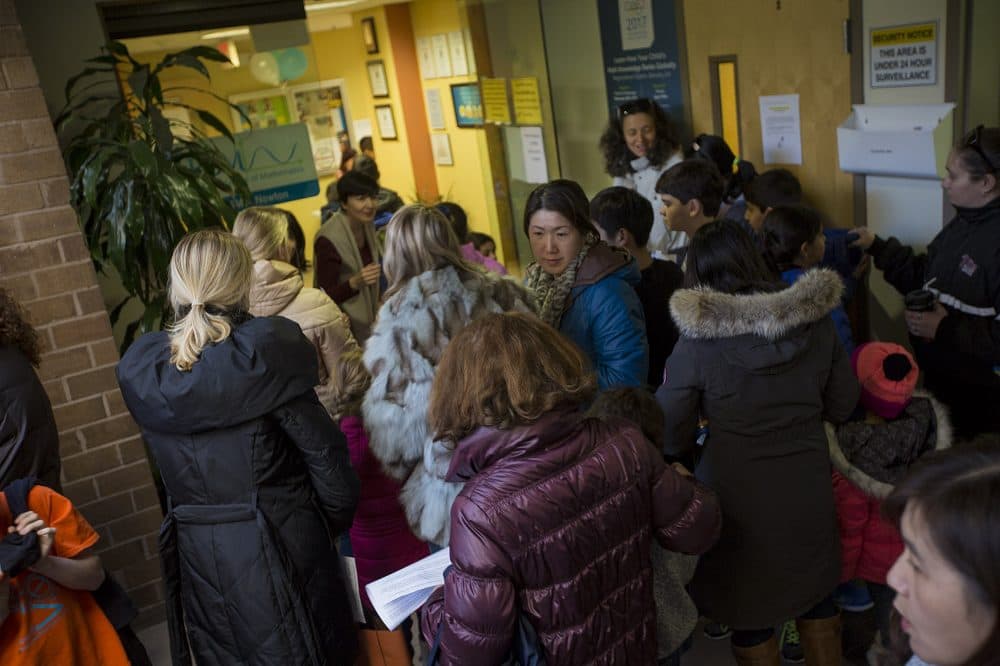 Parents flood the entrance of the Russian School of Mathematics in Newton to drop off their children before the Math Kangaroo competition. (Jesse Costa/WBUR)