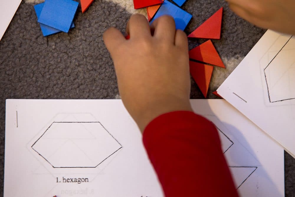 Students do geometric shape puzzles at a Studio of Engaging Math class for kindergartners. (Jesse Costa/WBUR)