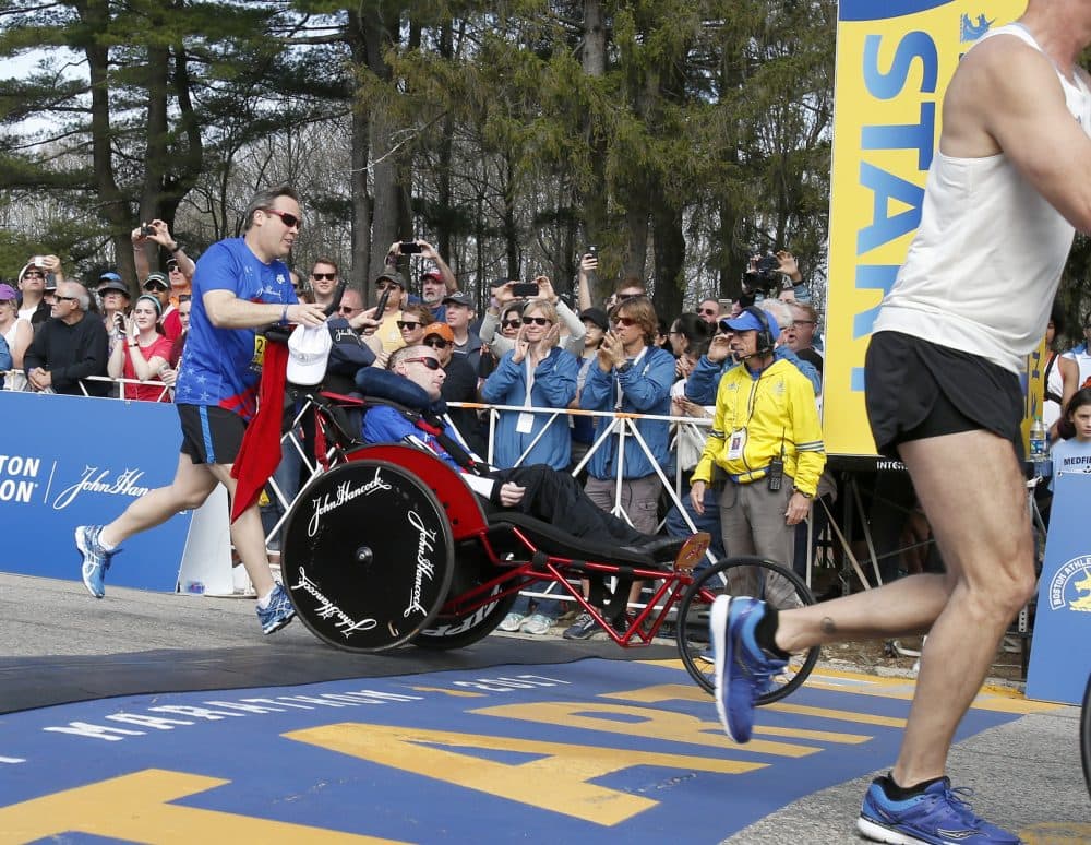 Bryan Lyons pushes Rick Hoyt across the start line in Hopkinton Monday morning. (Mary Schwalm/AP)