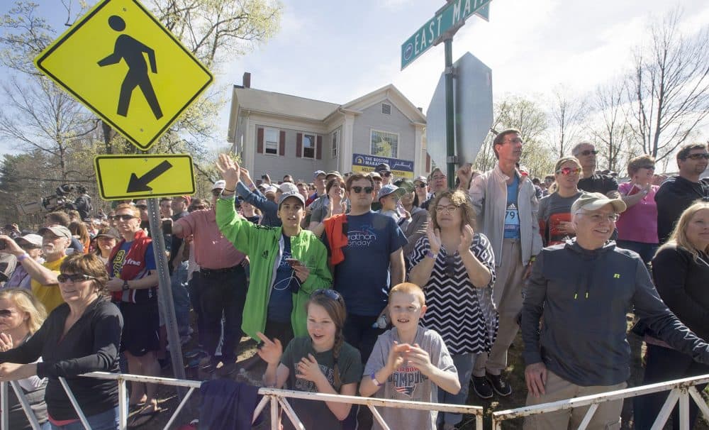 Fans cheer at the start of the race in Hopkinton. (Joe Difazio for WBUR)