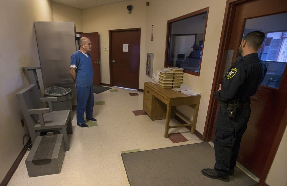 Alptekin waits to be frisked before returning to his cell at the Bristol County House of Corrections. (Jesse Costa/WBUR)