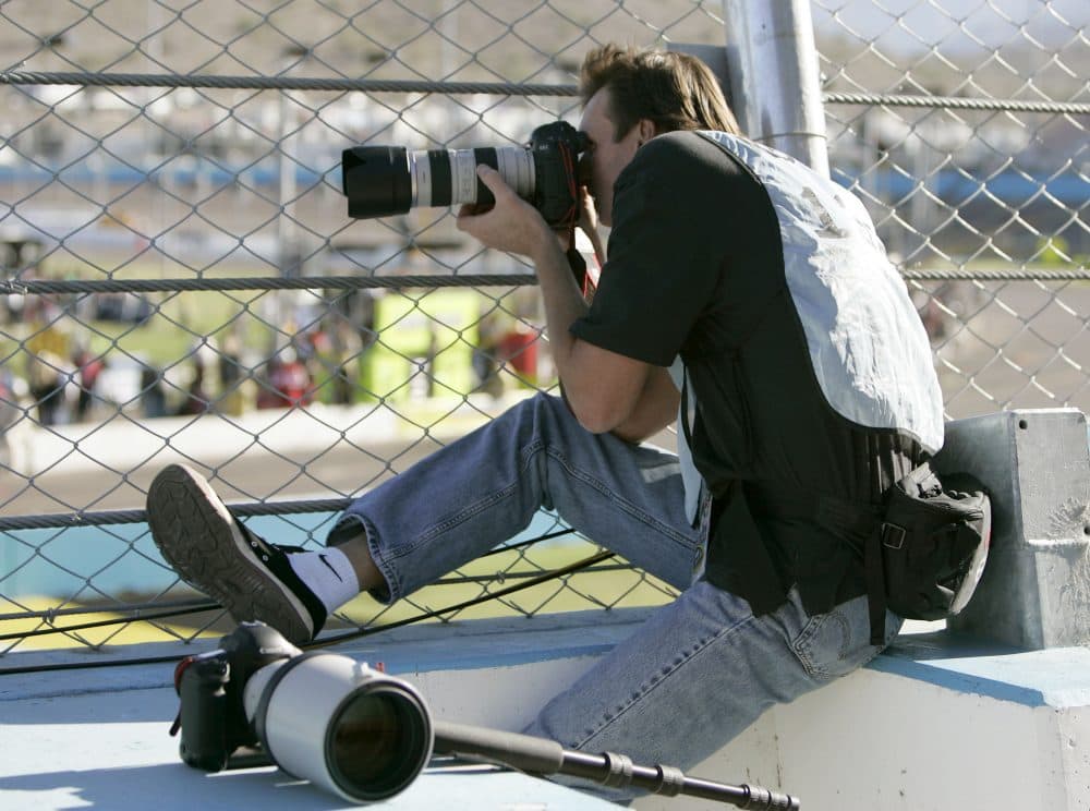 Johnson photographs a NASCAR race. (Jason Babyak/AP)