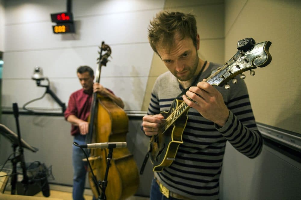 Chris Thile, right and Edgar Meyer playing with Yo-Yo Ma. (Jesse Costa/WBUR)