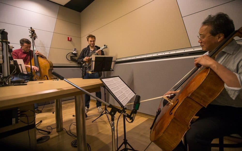 Yo-Yo Ma (right) playing with Chris Thile (center) and Edgar Meyer in the WBUR studios. (Jesse Costa/WBUR)