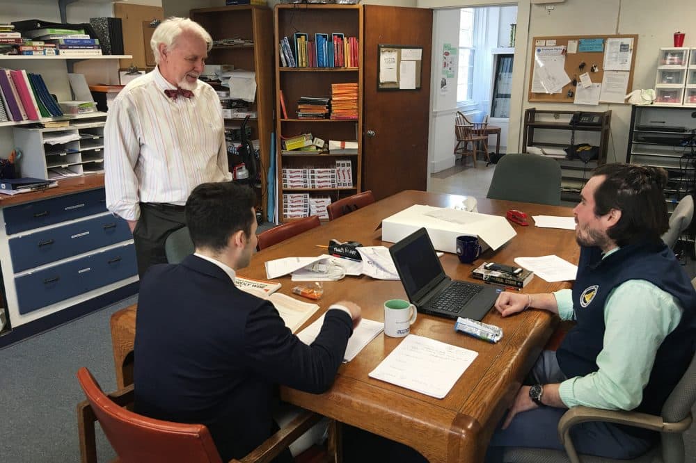 Headmaster John Martin talks with some AmeriCorps teaching staff. (Tonya Mosley/WBUR)