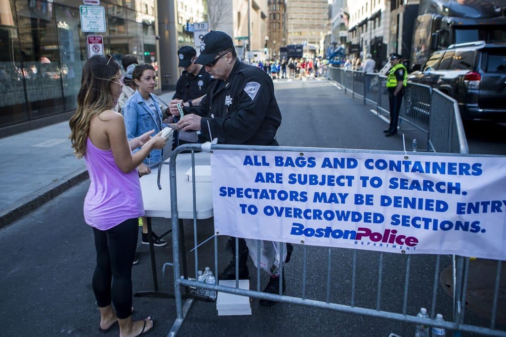 Security guards check spectators bags at a checkpoint downtown. (Jesse Costa/WBUR)