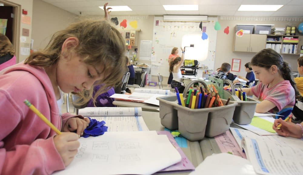 In this Tuesday, May 8, 2012 photo, second-grader Jessica Levy, left, works on math problems at Moreland Hills Elementary School in Pepper Pike, Ohio. As Ohio prepares by 2014 to join other states that deliver building-by-building percentages on classroom spending to parents and politicians, school treasurers and state funding experts are struggling to shove expenses as varied as guidance counseling, teacher pensions, school buses, furnace ducts, and playground equipment into a single two-category system. (AP Photo/Tony Dejak)