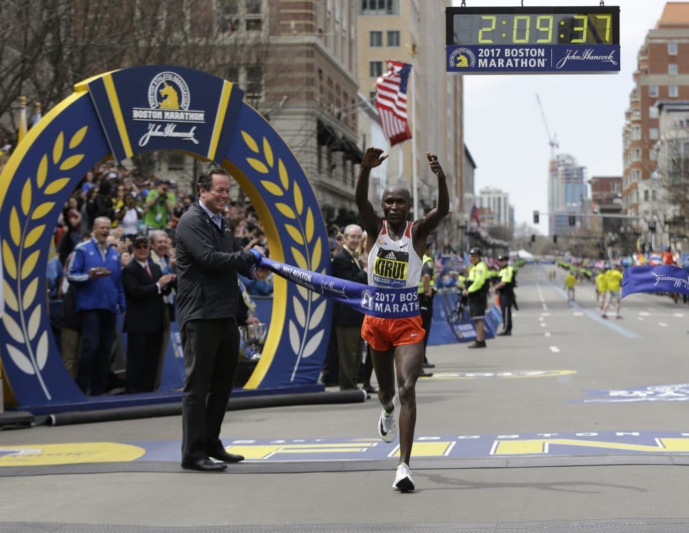 Geoffrey Kirui, of Kenya, crosses the finish line to win the 121st Boston Marathon. (Elise Amendola/AP)