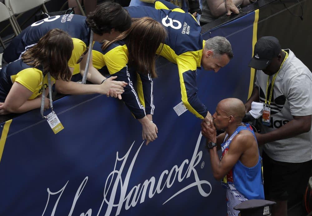 Meb Keflezighi, who won the 2014 Boston Marathon, greets the family of 2013 Boston Marathon bombing victim Martin Richard after he finished Monday. (Charles Krupa/AP)