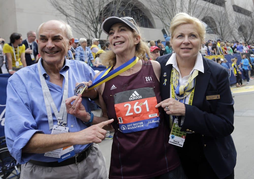 Kathrine Switzer, center, the first official woman entrant in the Boston Marathon 50 years ago, wears the same bib number after finishing the marathon on MondayWith Switzer are her husband Roger Robinson, left, and Joann Flaminio, right, of the Boston Athletic Association. (Elise Amendola/AP)