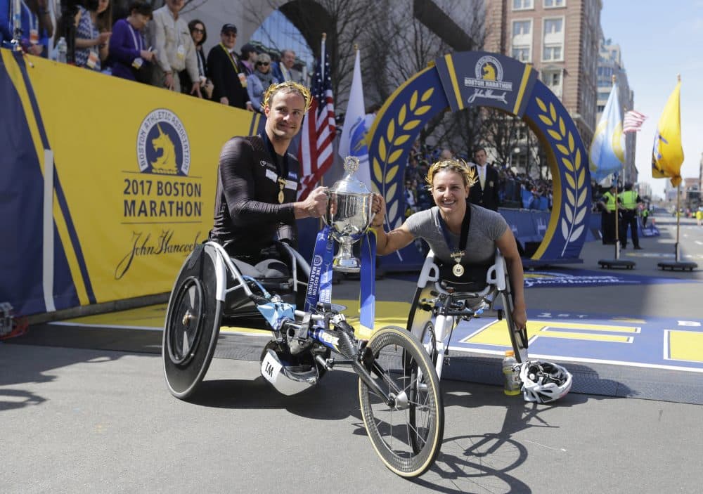 Wheelchair division winners Manuela Schar, right, and Marcel Hug, both of Switzerland, pose after their wins in the 121st Boston Marathon women's and men's wheelchair divisions. (Elise Amendola/AP)