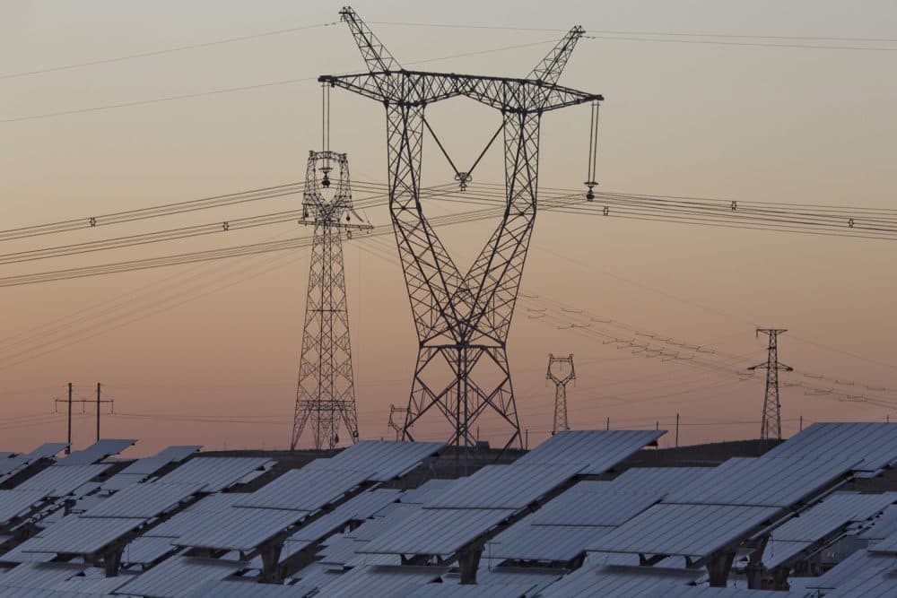 In this Oct. 9, 2015, file photo, solar panels are seen near the power grid in northwestern China's Ningxia Hui autonomous region. (Ng Han Guan/AP)