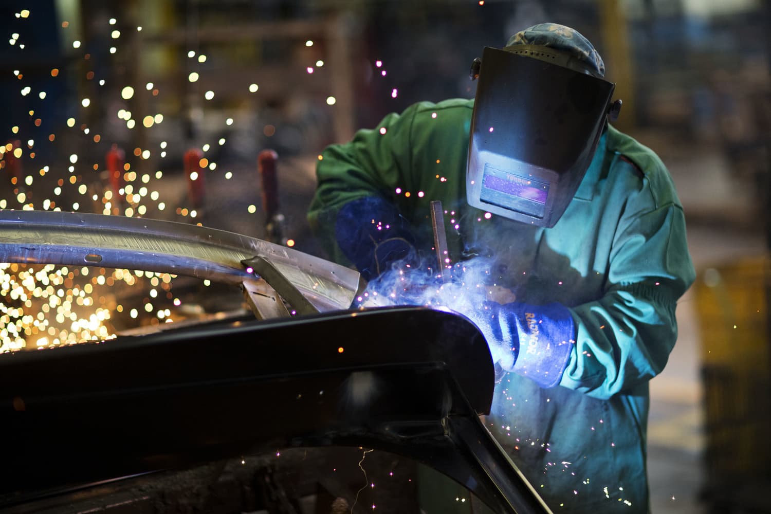  In this Sept. 18, 2015 file photo, sparks fly as a welder works on a frame for a school bus at Blue Bird Corporation's manufacturing facility in Fort Valley, Ga. (David Goldman/AP)