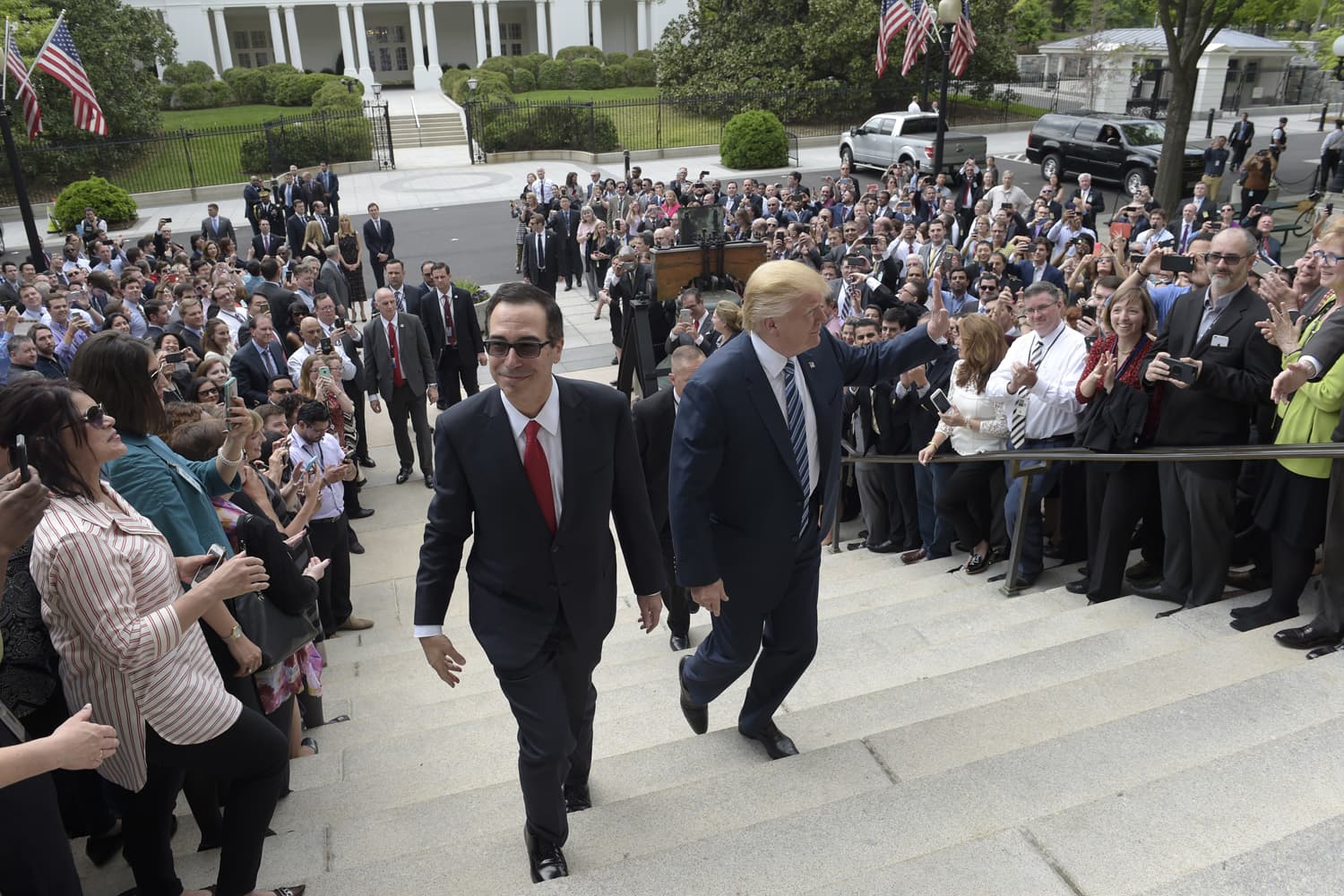 President Donald Trump and Treasury Secretary Steven Mnuchin arrive at the Treasury Department in Washington, Friday, April 21, 2017, where the president was to sign an executive order to review tax regulations. (AP Photo/Susan Walsh)